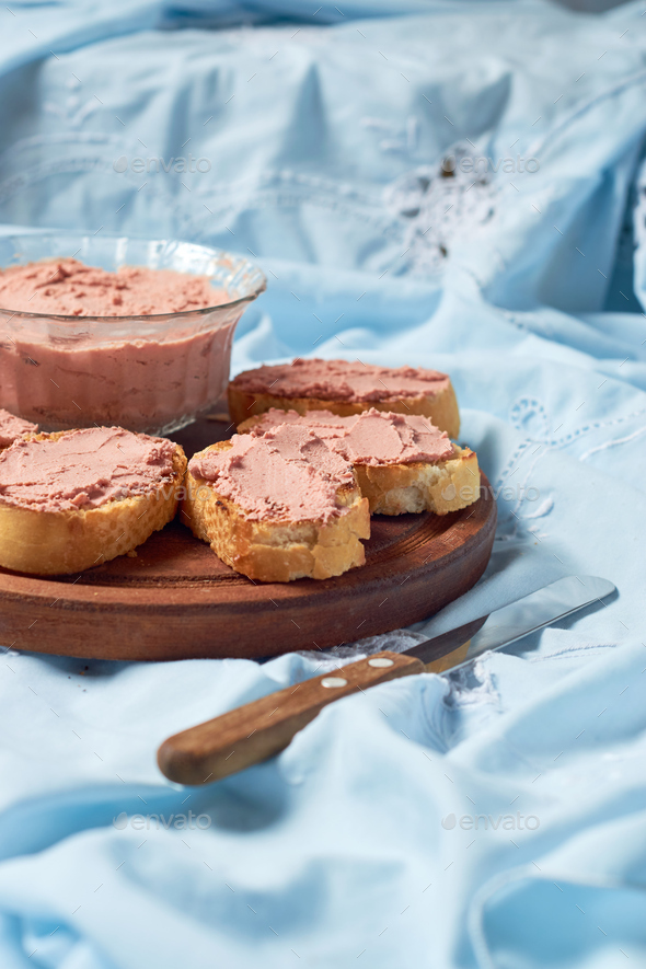Bread toast with pork liver pâté on a rustic background. Stock Photo by